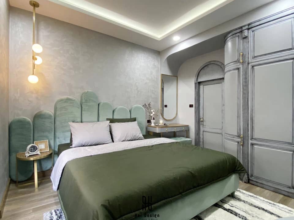 Phòng ngủ master Sunrise Riverside với giường xanh olive và đầu giường bo cong