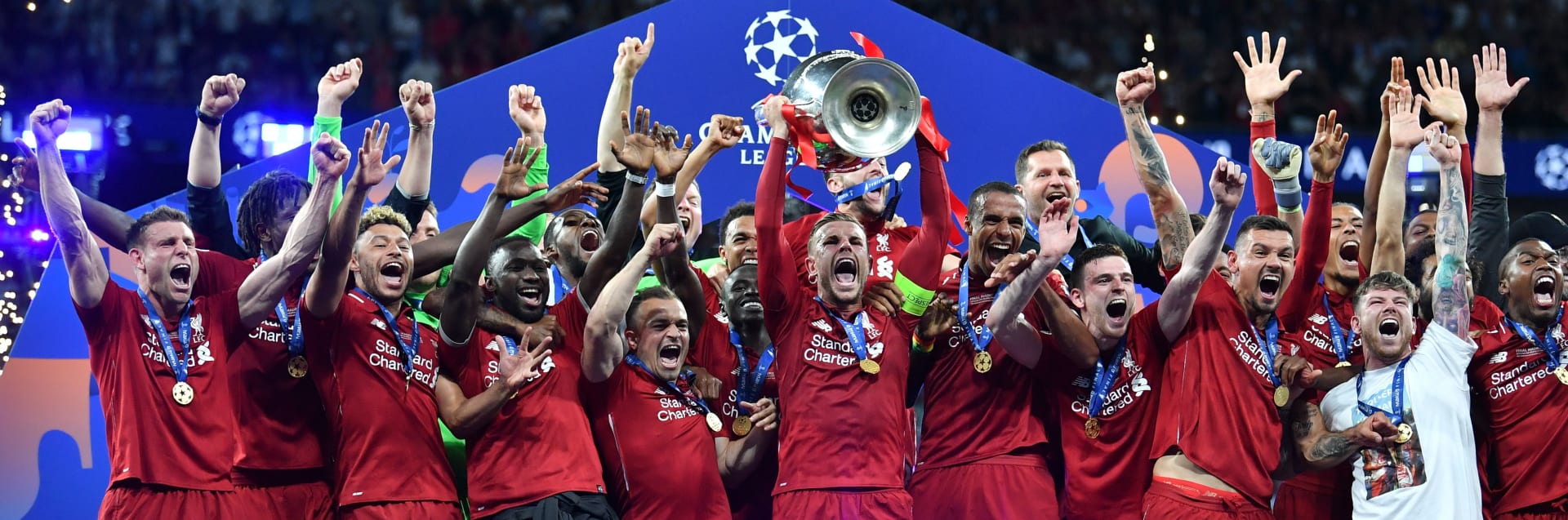 Liverpool's English midfielder Jordan Henderson raises the trophy after winning the UEFA Champions League final football match between Liverpool and Tottenham Hotspur at the Wanda Metropolitano Stadium in Madrid on June 1, 2019. (Photo by Ben STANSALL / AFP)        (Photo credit should read BEN STANSALL/AFP via Getty Images)