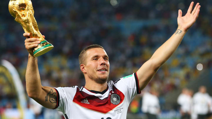 Germany v Argentina: 2014 FIFA World Cup Brazil Final RIO DE JANEIRO, BRAZIL - JULY 13: Lukas Podolski of Germany celebrates with the World Cup trophy after defeating Argentina 1-0 in extra time during the 2014 FIFA World Cup Brazil Final match between Germany and Argentina at Maracana on July 13, 2014 in Rio de Janeiro, Brazil. (Photo by Julian Finney/Getty Images)