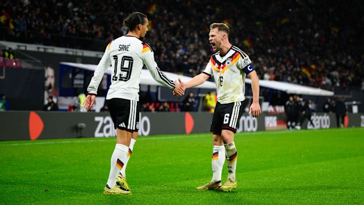 Leroy Sane and Joshua Kimmich face each other on the pitch.