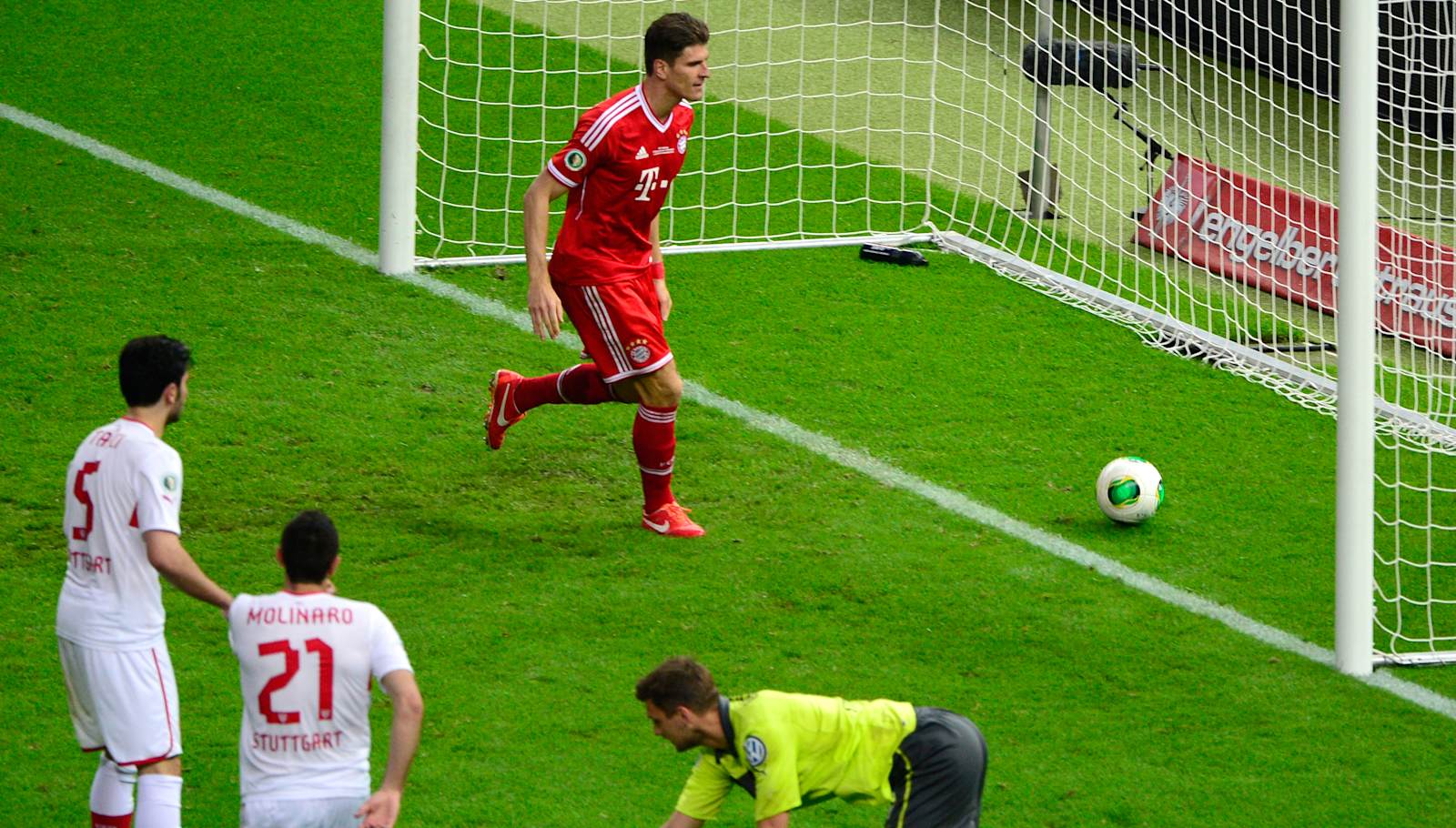 Bayern Munich's striker Mario Gomez (up) scores next to Stuttgart's goalkeeper Sven Ulreich (bottom R) during the final football match of the German Cup (DFB - Pokal) FC Bayern Munich vs VfB Stuttgart on June 1, 2013 at the Olympic Stadium in Berlin. AFP PHOTO / JOHN MACDOUGALLRESTRICTIONS / EMBARGO - DFL LIMITS THE USE OF IMAGES ON THE INTERNET TO 15 PICTURES (NO VIDEO-LIKE SEQUENCES) DURING THE MATCH AND PROHIBITS MOBILE (MMS) USE DURING AND FOR FURTHER TWO HOURS AFTER THE MATCH. FOR MORE INFORMATION CONTACT DFL        (Photo credit should read JOHN MACDOUGALL/AFP via Getty Images)