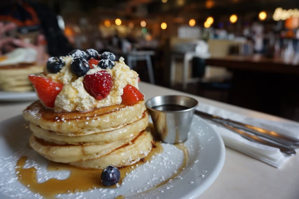 A stack of pancakes and berries at The Breakfast Club in Hackney Wick