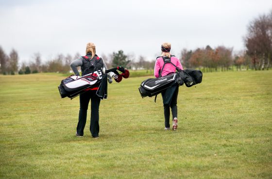 Ellie Robinson and female golfer on the golf course at Leeds Golf Centre