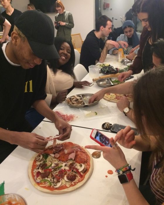 IconInc students topping their pizzas
