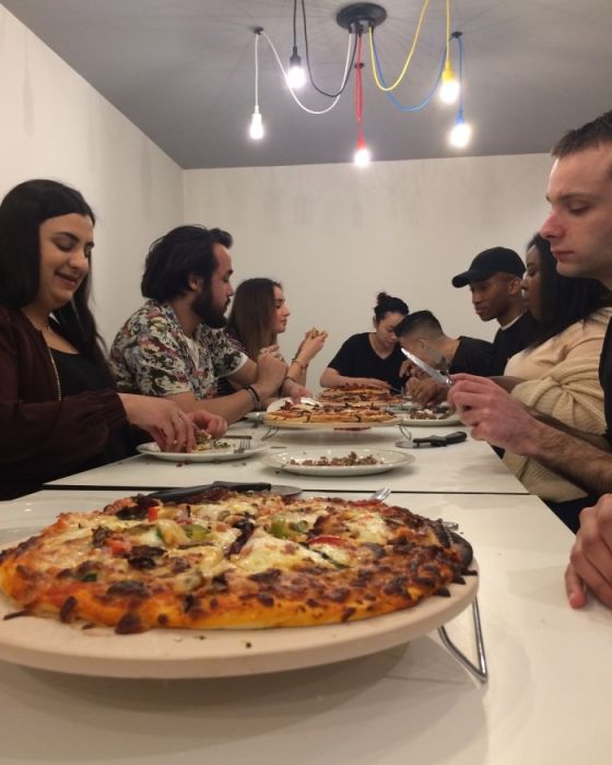 Students eating their pizzas, made with the help of Chris Hale