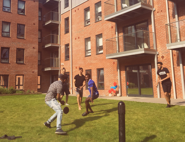 Students playing football in courtyard at IconInc The Glassworks