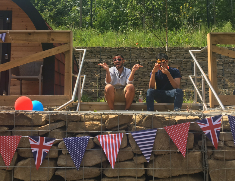 Two male students sat on steps at IconInc's summer party