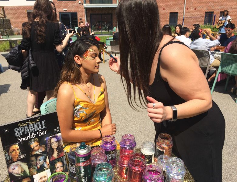 Student getting glitter makeup from wish upon a sparkle