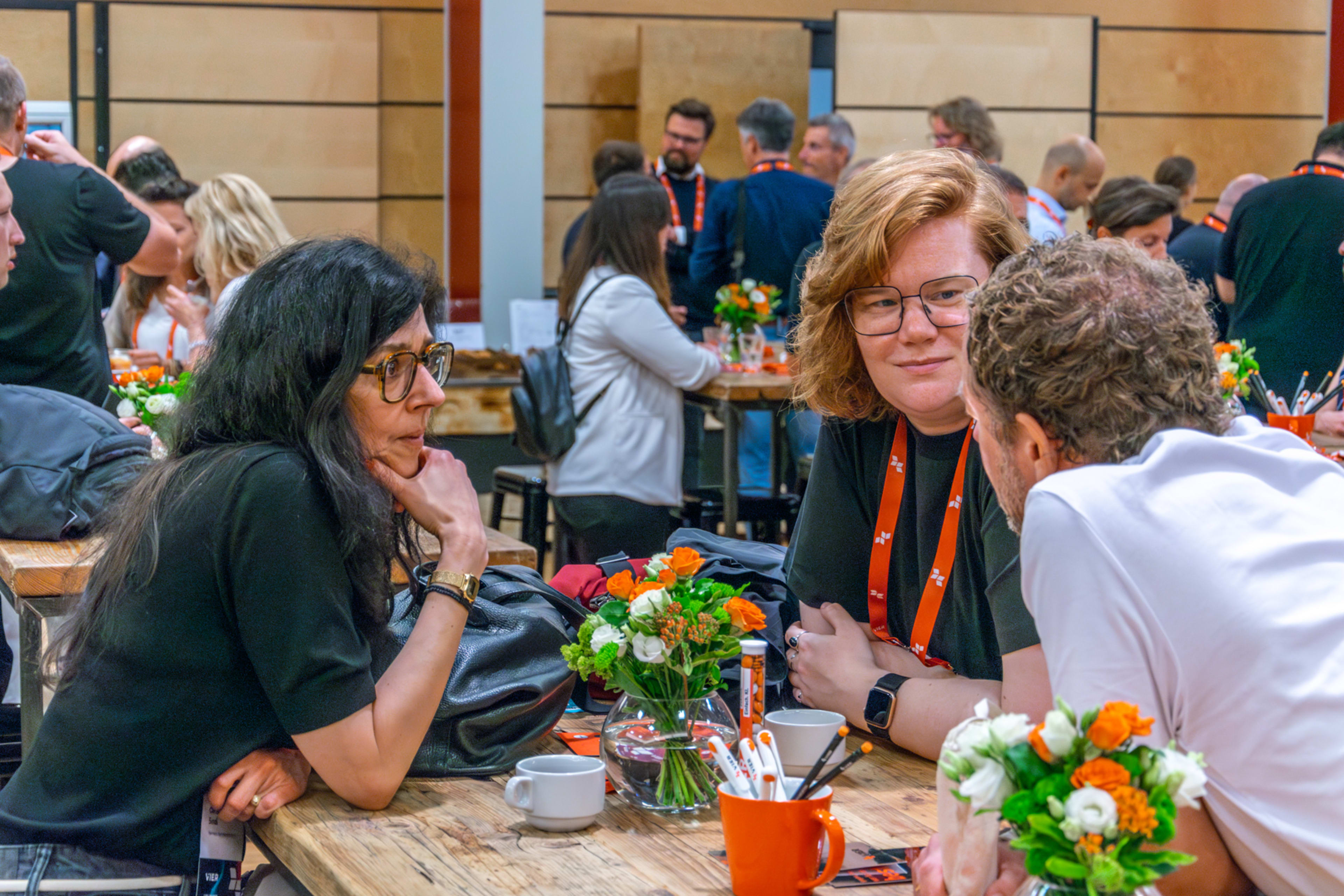 Several groups of people engaging in lively conversations.
