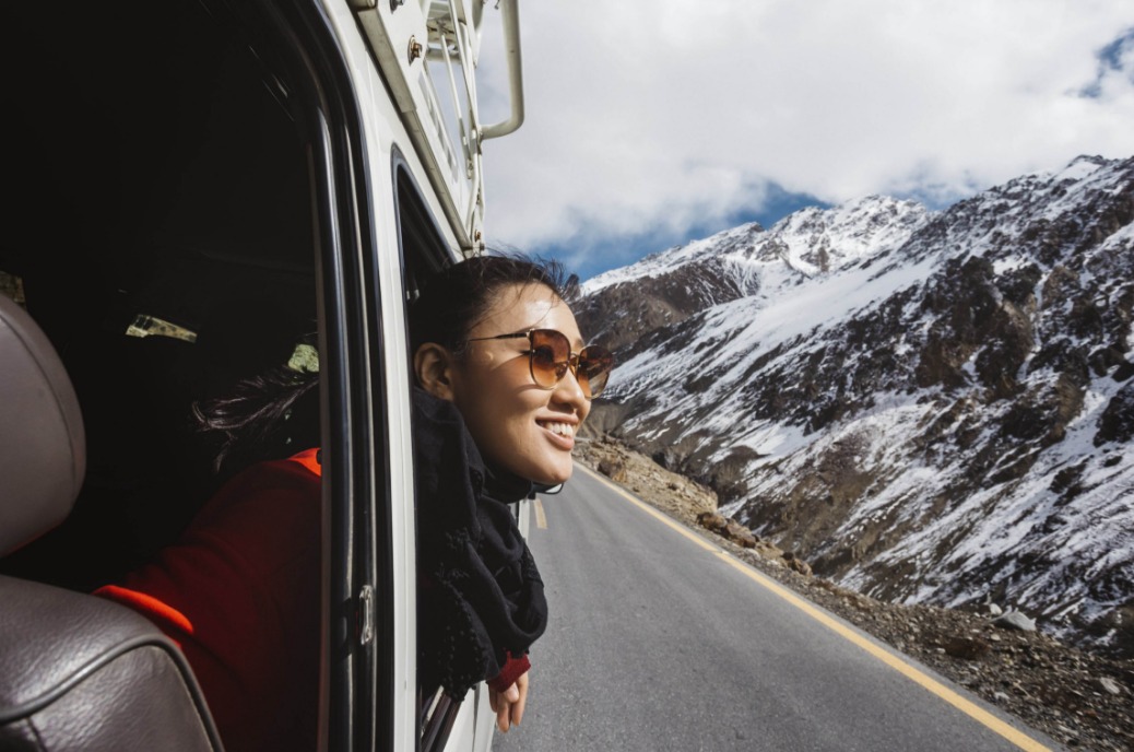 woman-with-her-head-out-of-a-van-looking-at-the-view.jpeg