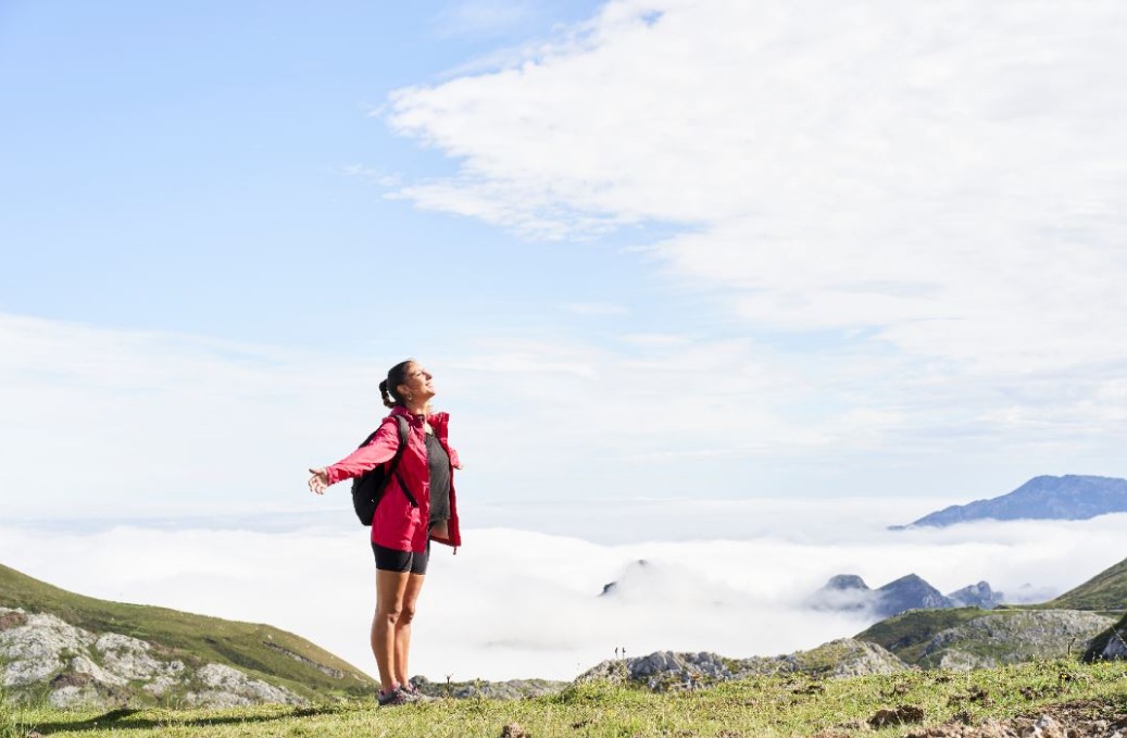 female-hiker-on-top-of-mountain-with-opened-arms-in-the-direction-of-the-sun.jpeg