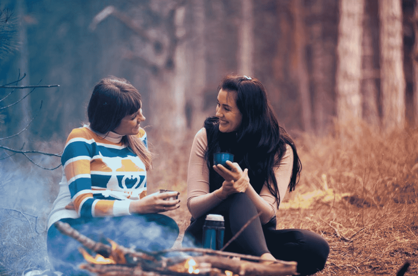 women camping and laughing.png