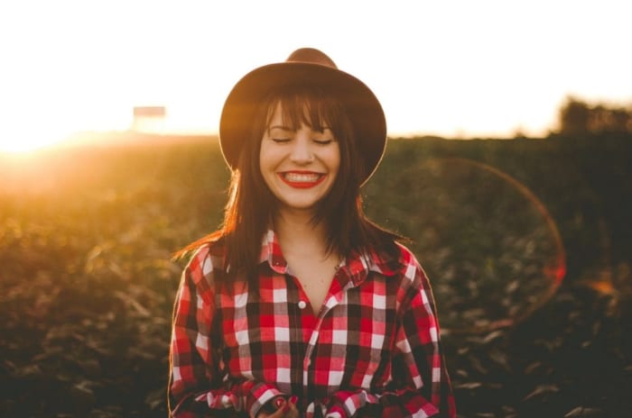 smiling woman with closed eyes and a sunset  .jpeg