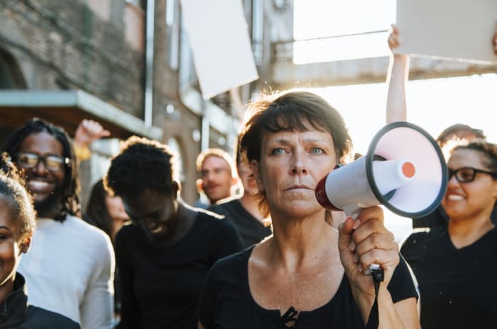 woman-holding-a-microphone-during-a-demonstration-in-the-street.jpeg