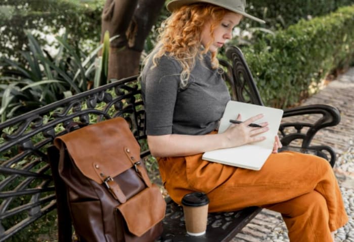 Woman readin a travel notebook.JPG