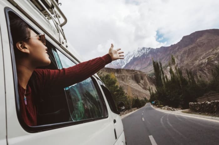 woman roadtripping by car.jpeg