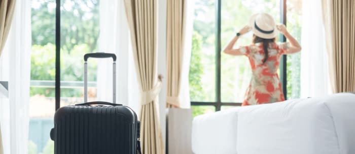 A woman checking in a hotel room.png