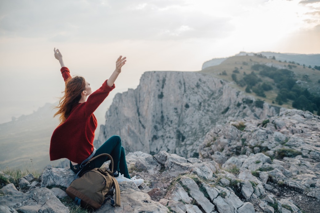 woman-with-open-arms-as-a-sign-of-freedom-on-top-of-a-mountain.jpeg