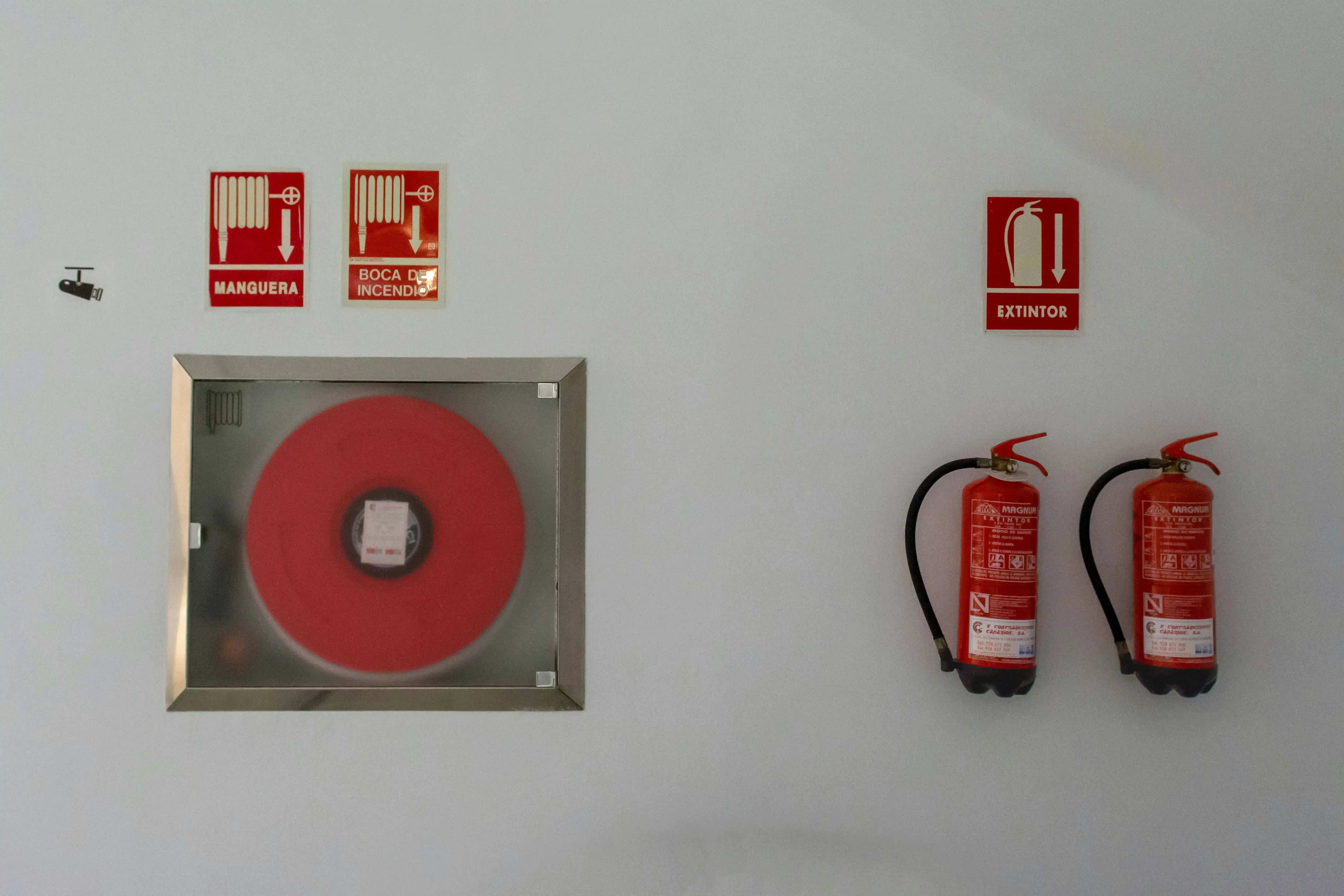 Technician performing routine maintenance on fire safety equipment