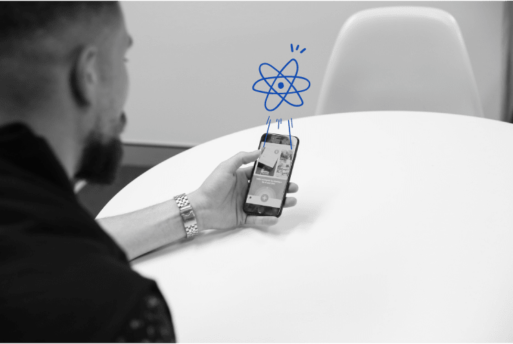 A photo of a man using a phone with an app on the screen