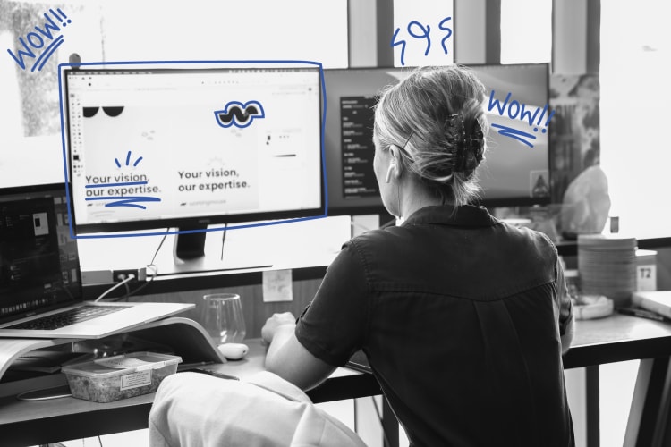 A black and white photo of a woman using a computer