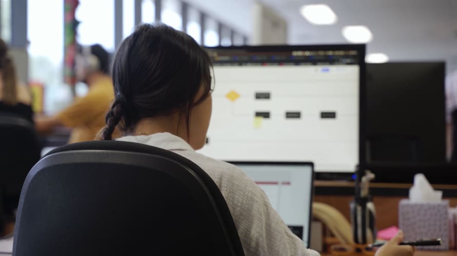 A photo of a woman working on a laptop