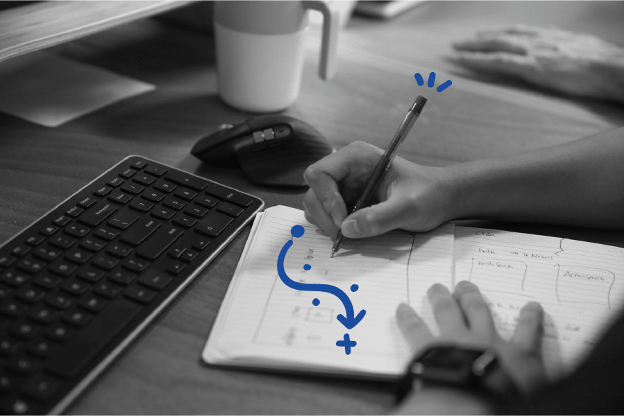 A close up of someones hands drawing a desgin