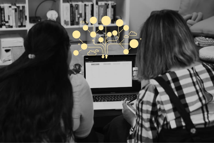 Two women looking at a  laptop