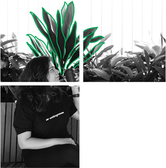 A woman drinking coffee and standing infront of some plants