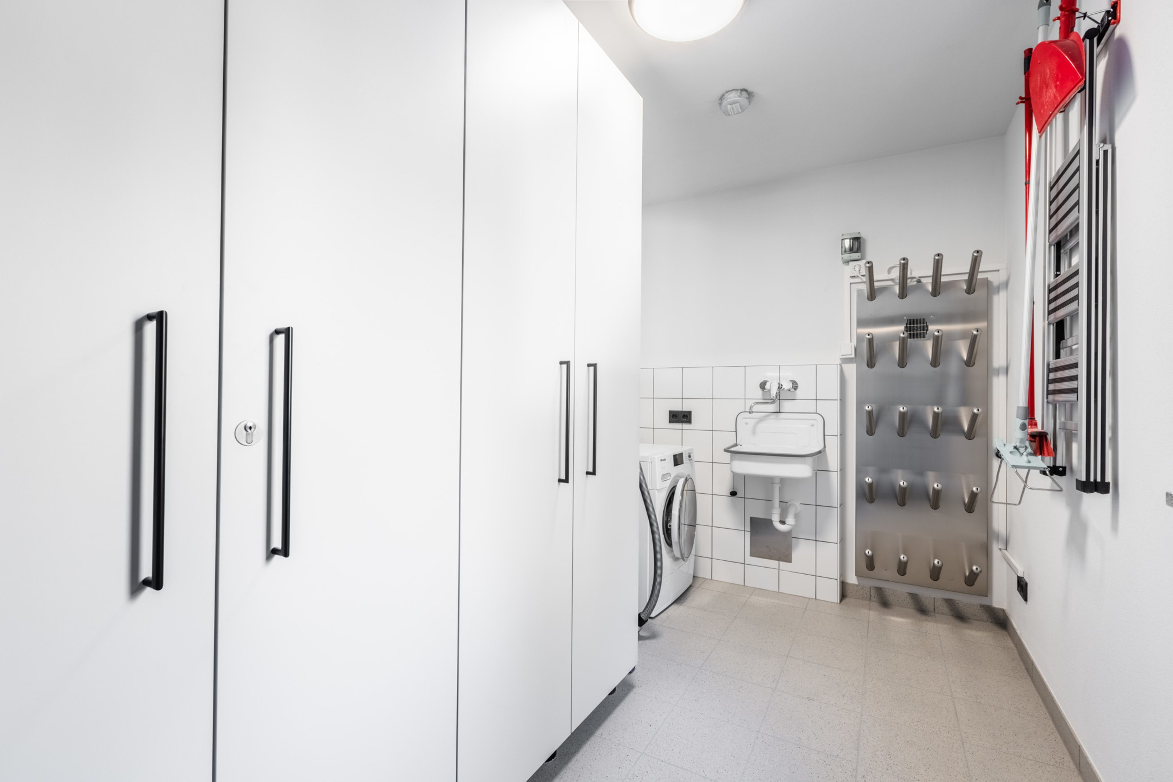 Skiraum mit Halterungen für Skischuhe und Ausrüstung sowie Waschbecken