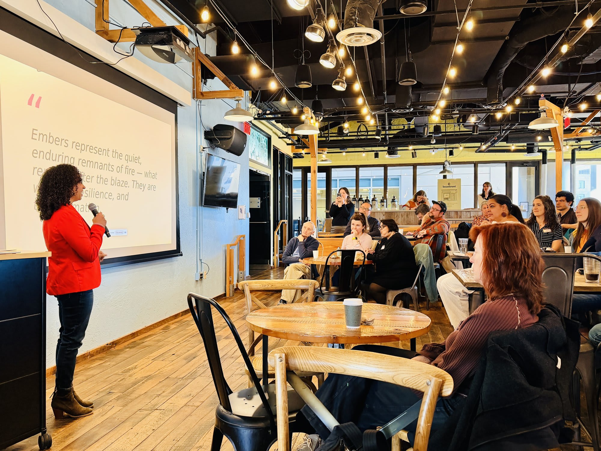 Kira Troilo speaking on stage at CreativeMornings Boston