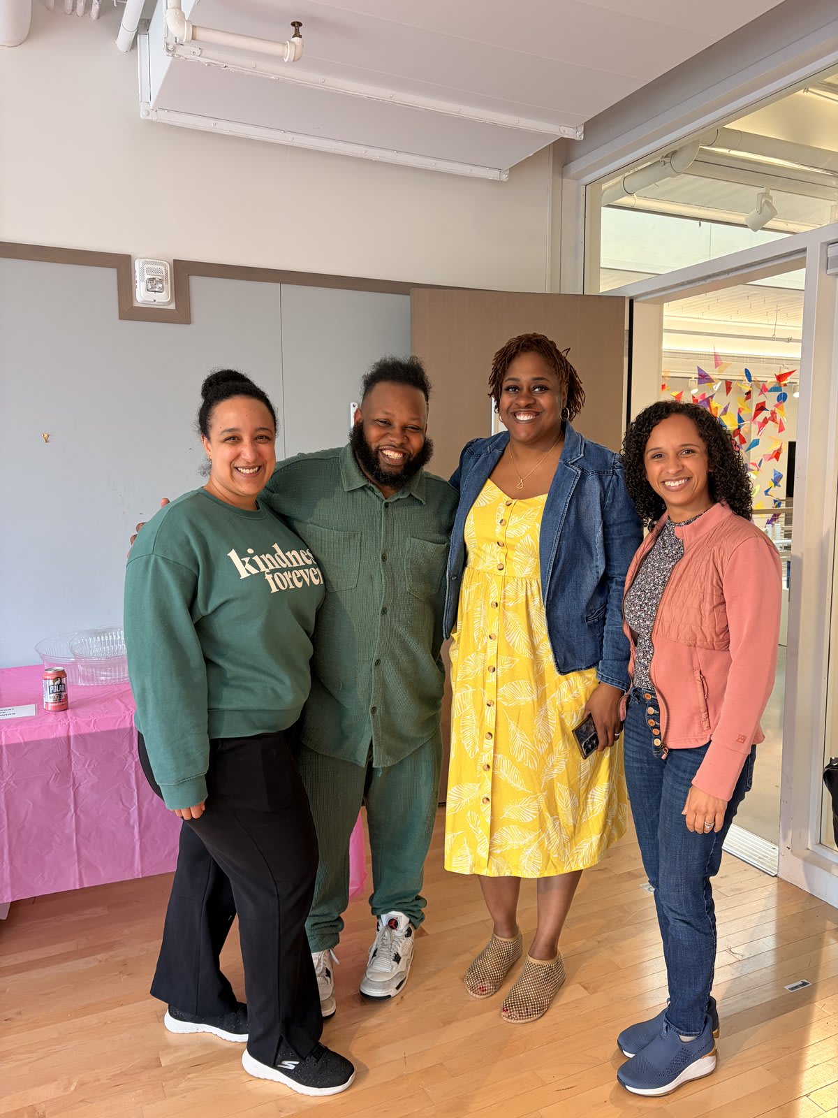 Kira Troilo with team members Ari, Najee, and Nadja, smiling together backstage