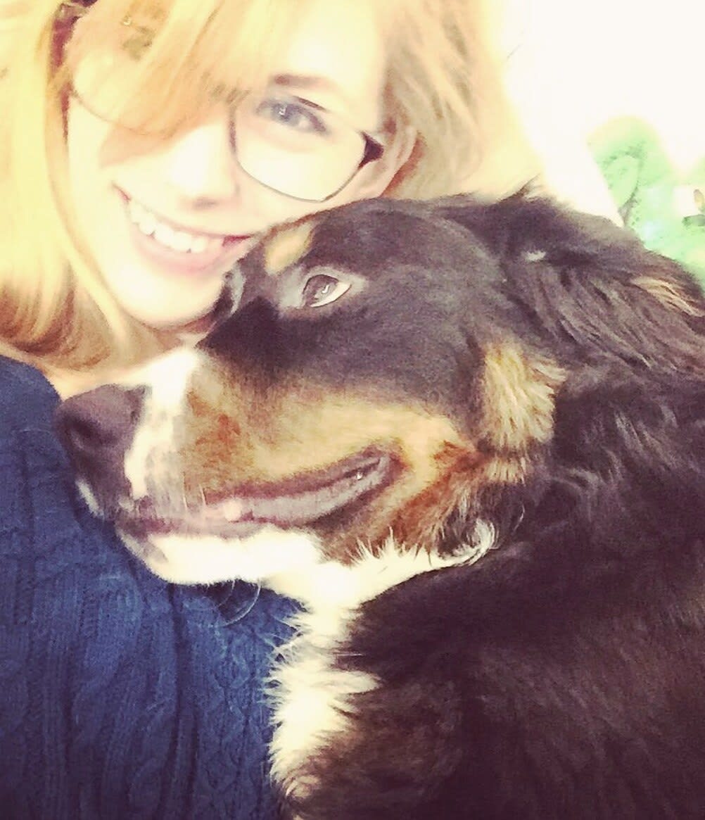 Charlie cheek to cheek with a smiling Bernese mountain dog
