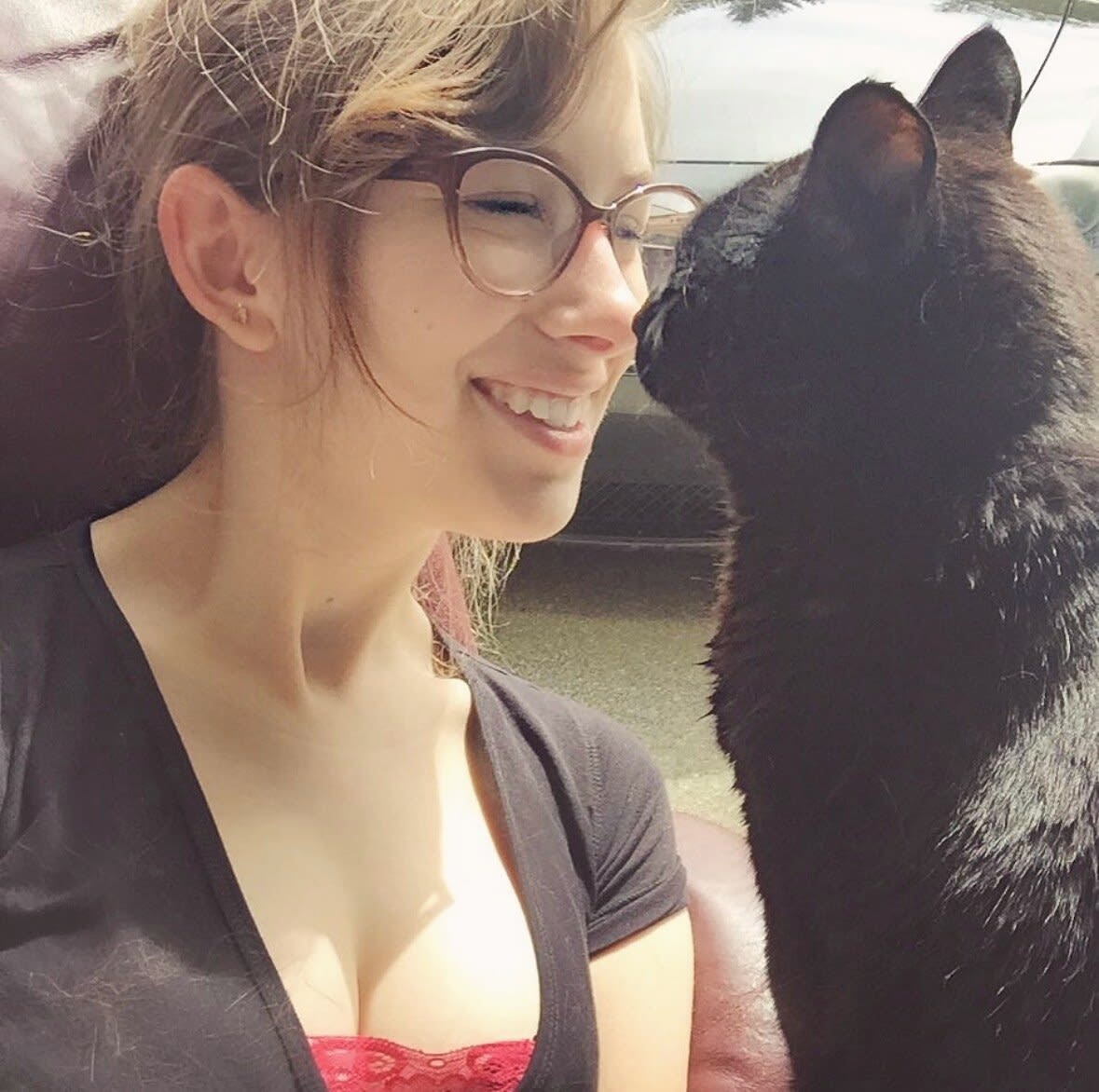 Charlie smiling nose to nose with a black cat