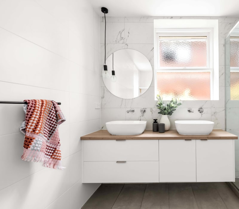 Melbourne bathroom renovation. Warm, white cabinetry with wooden benchtop