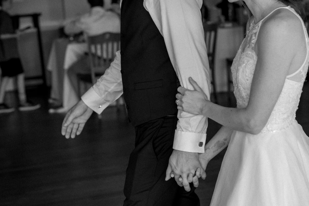 Intimate hand-holding moment at a microwedding in Downtown Fredericksburg, Virginia