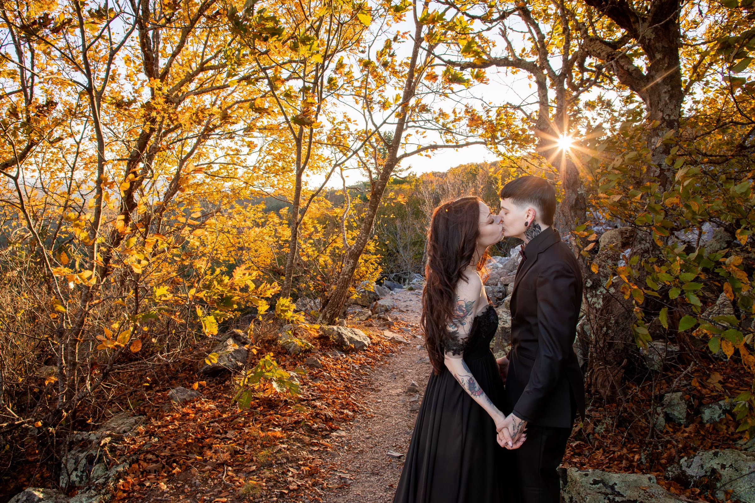 Couple kissing on the Blackrock Summit trail surrounded by golden fall foliage