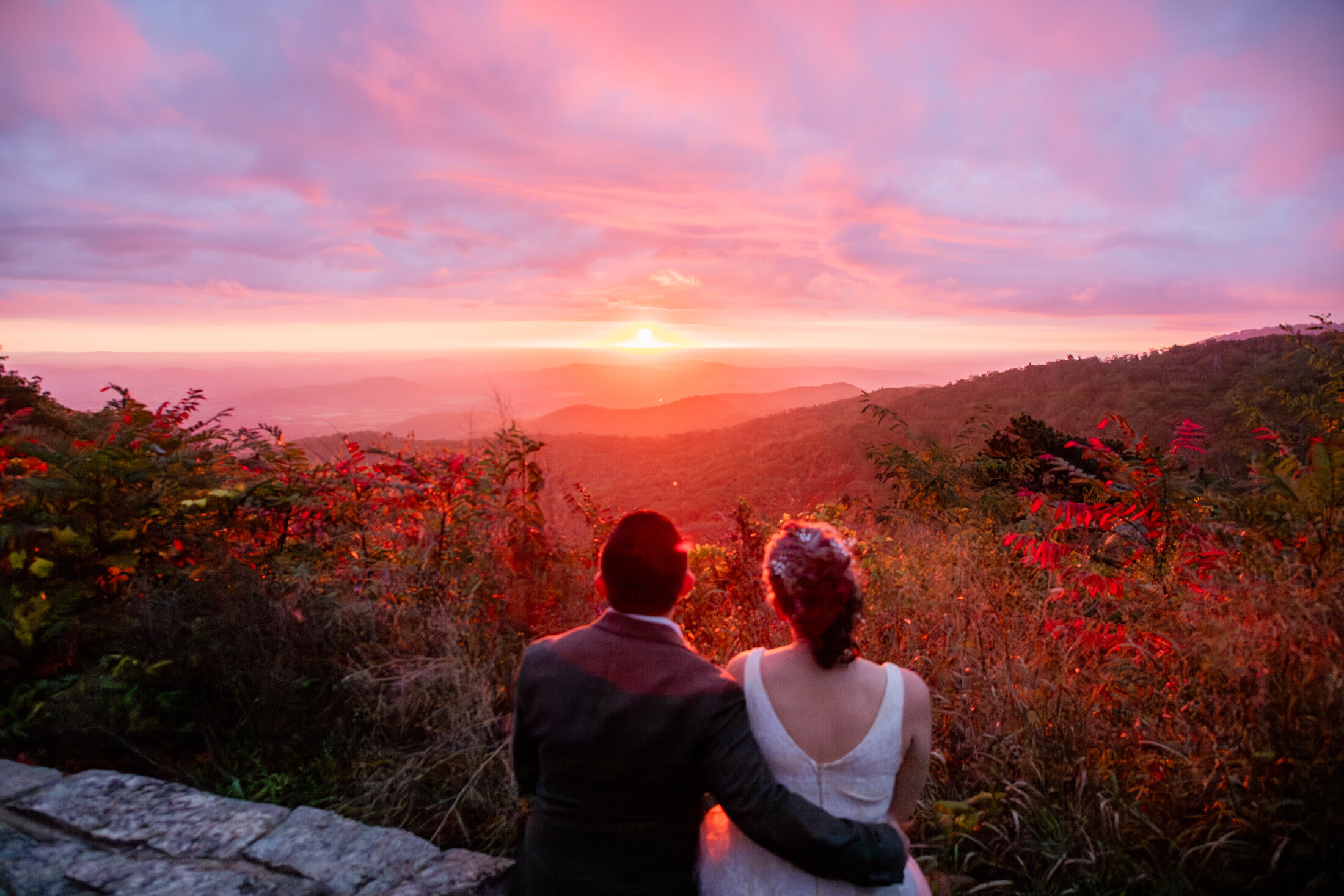 Couple embracing at sunrise in Shenandoah National Park during their elopement