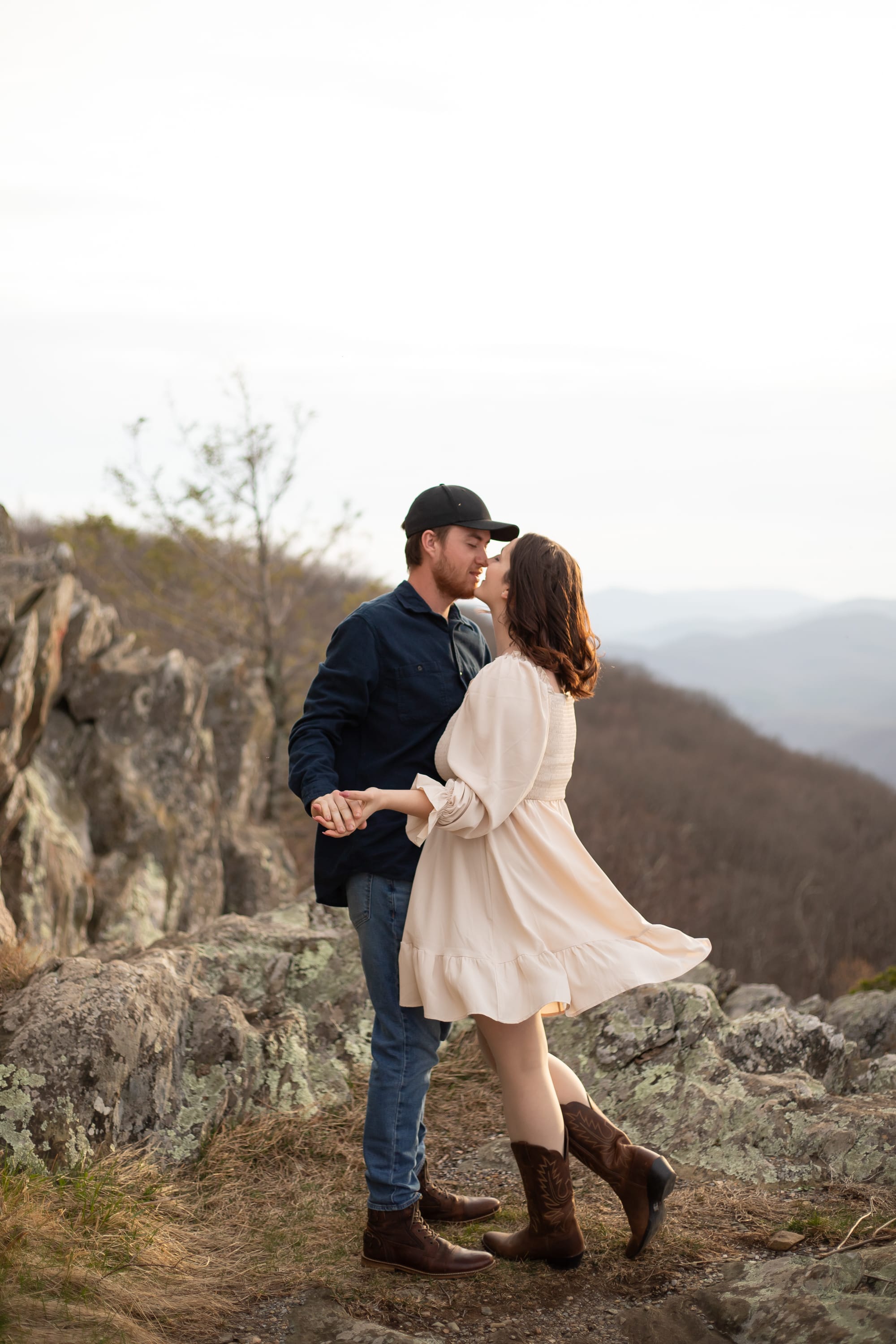 Couple swaying in the gentle breeze at Raven's Roost Overlook with the Blue Ridge Mountains in the distance, Virginia