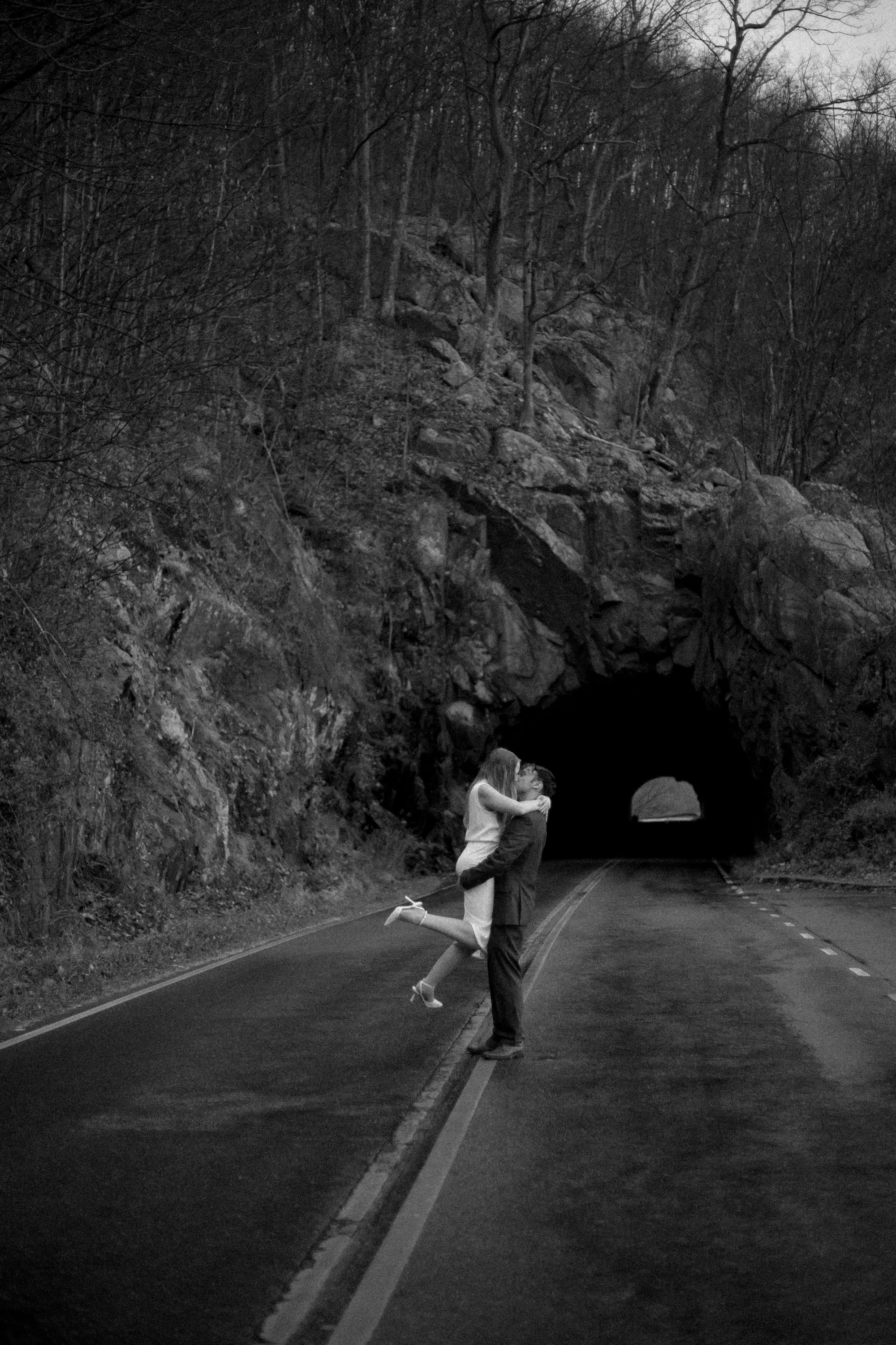 couple running and jumping into a kiss in the rain during their Shenandoah National Park elopement