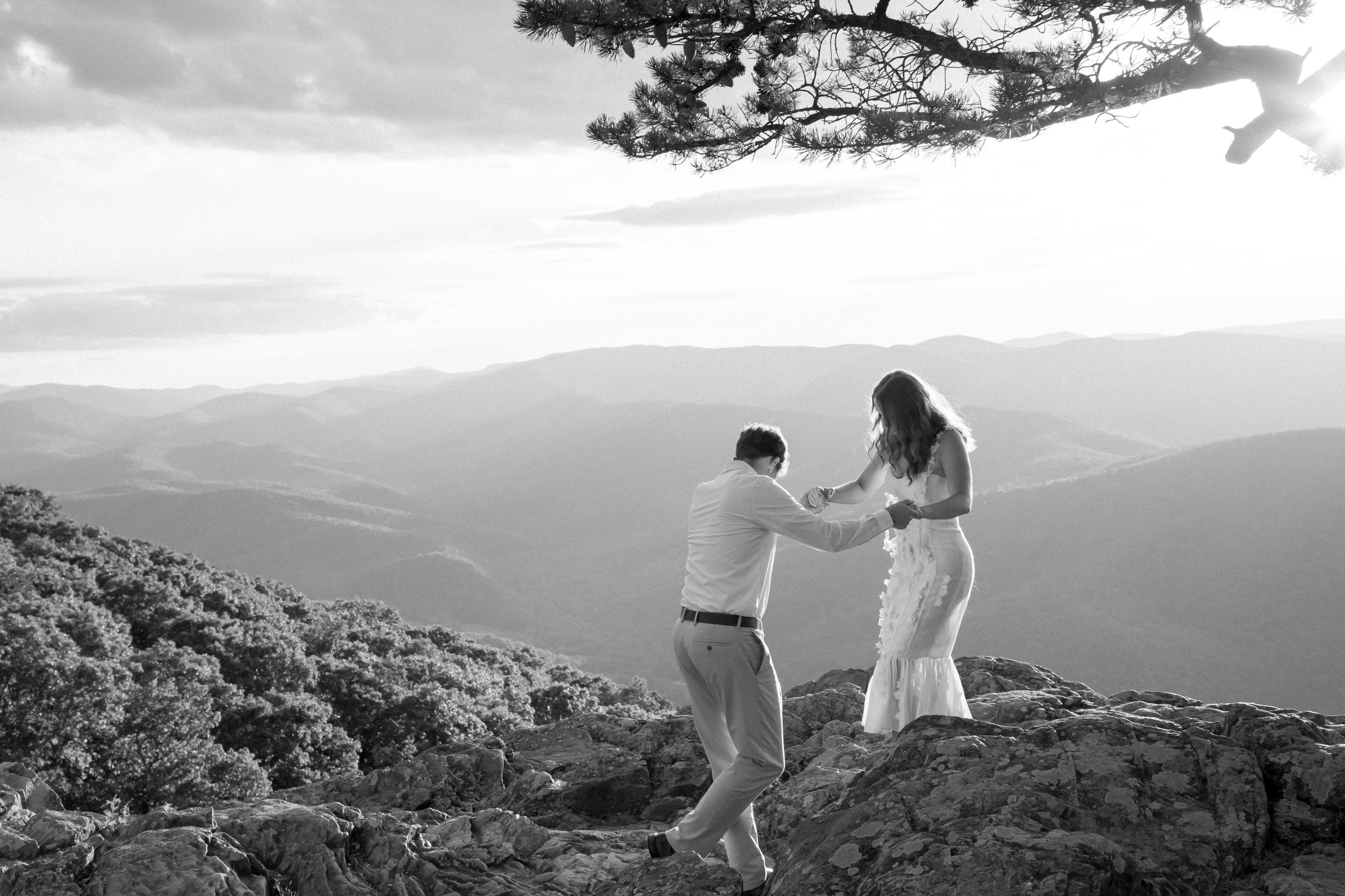 Sunlit romantic moment between couple at Raven's Roost Overlook on the Blue Ridge Parkway, Virginia