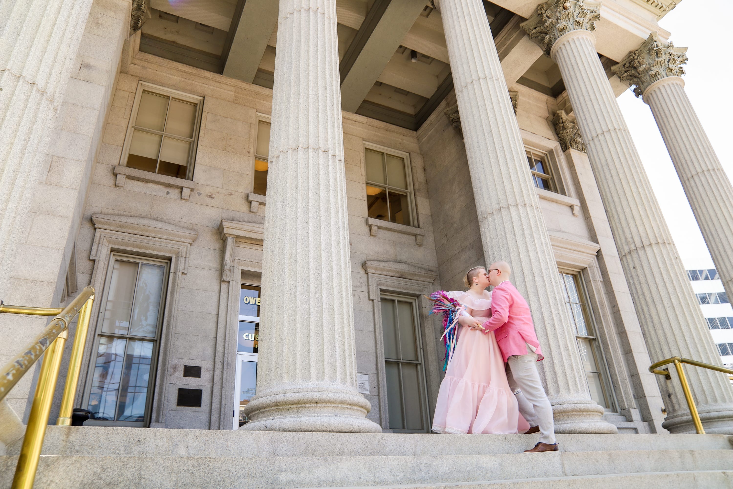 Couple kissing on the steps of a historic Virginia courthouse after their elopement ceremony