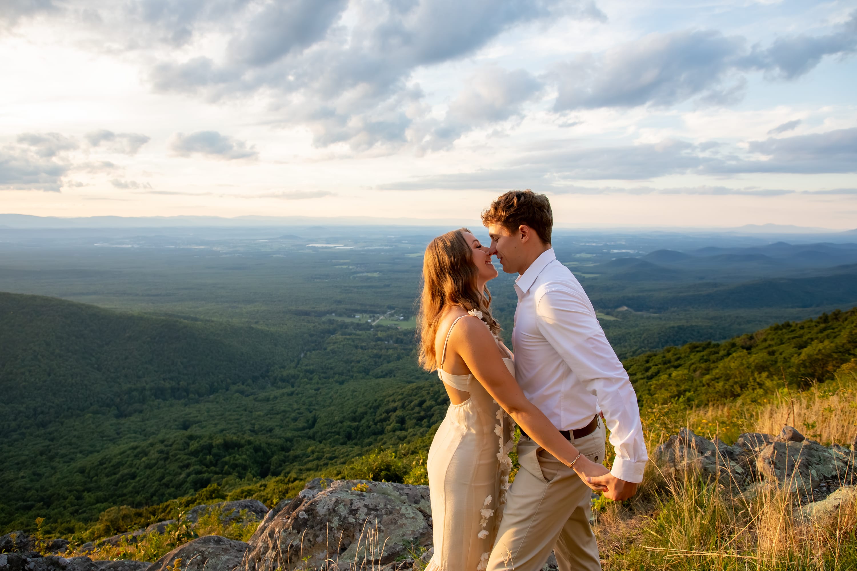 Golden light shining on a couple at Raven's Roost Overlook on the Blue Ridge Parkway, Virginia