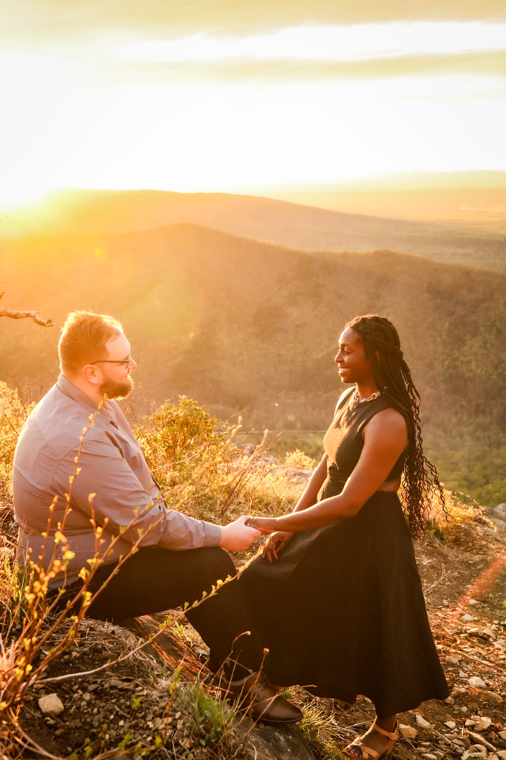 Romantic moment between a couple with the sun glowing over the mountains at Raven's Roost Overlook, Virginia