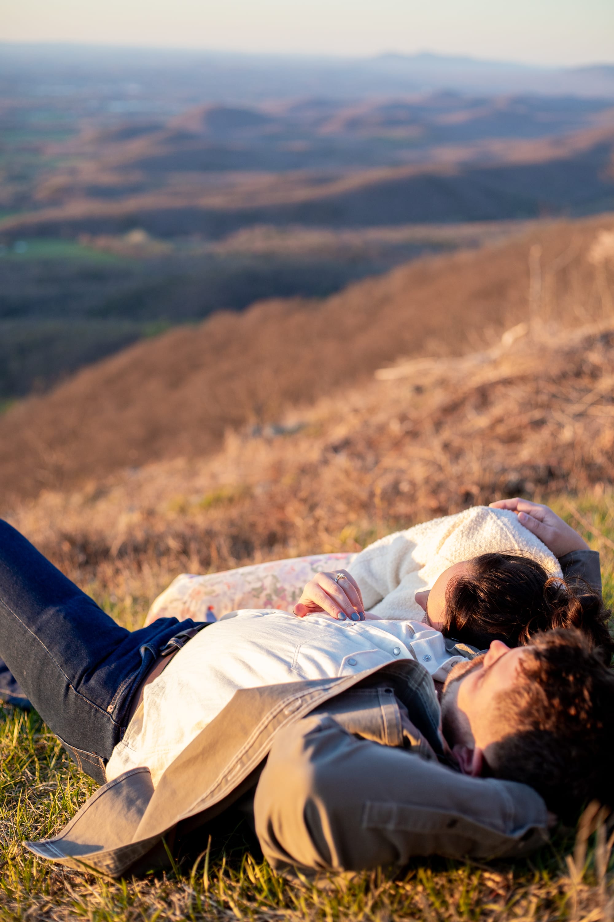 Couple amongst wildflowers on the mountainside in golden light at Raven's Roost Overlook, Blue Ridge Parkway