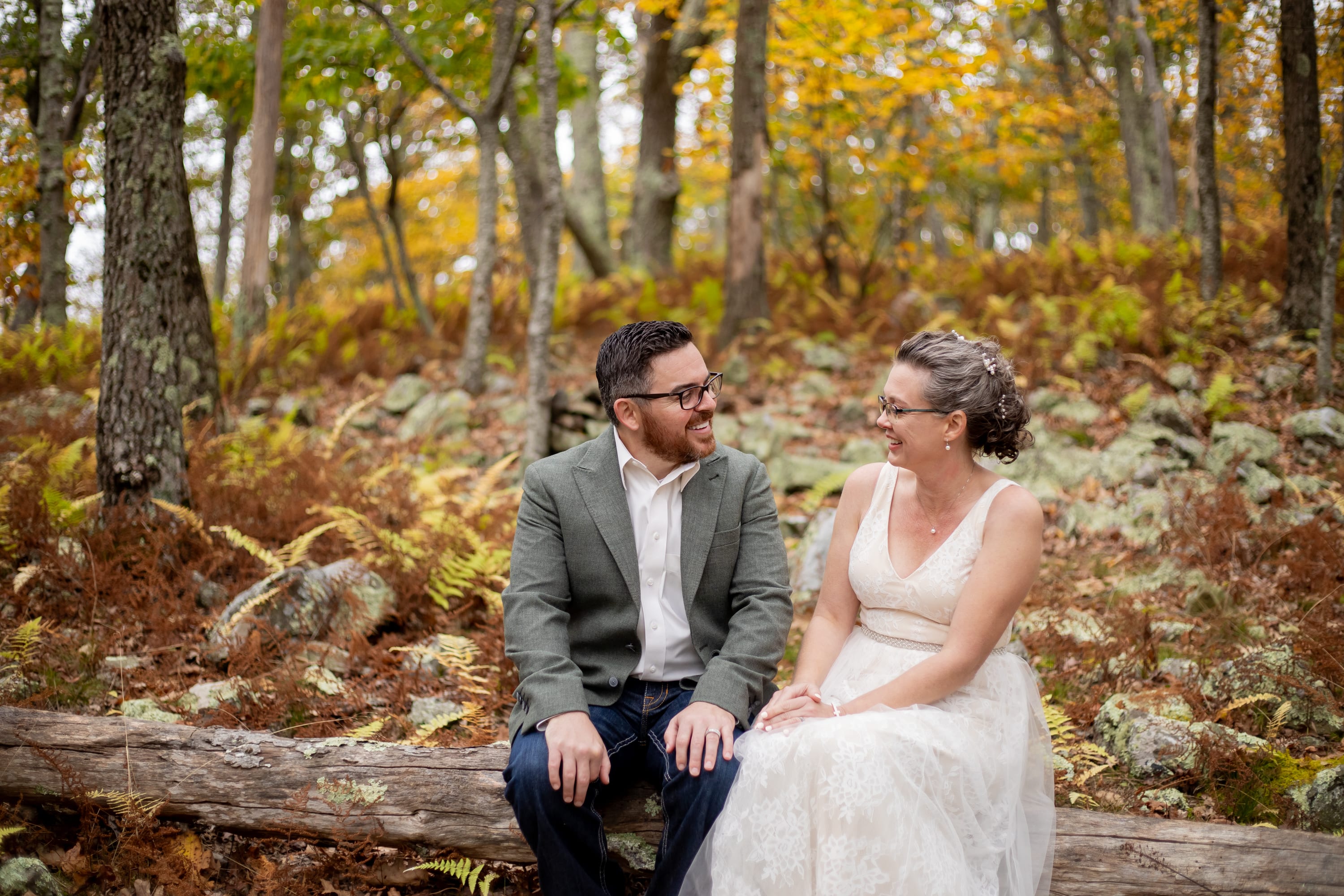 couple laughing together in the forest of Shenandoah National Park during peak fall foliage