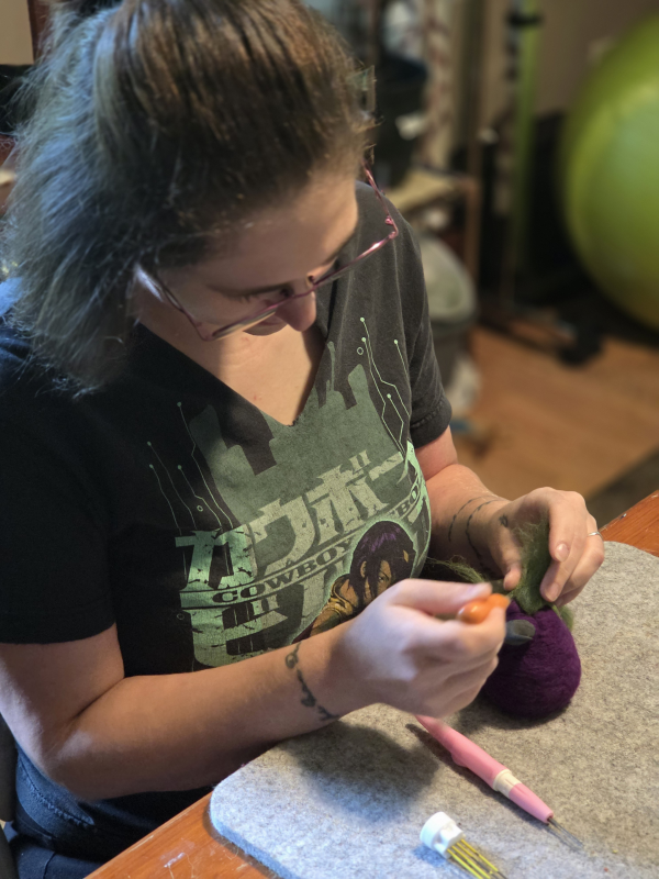 An artist working on a felt Deviled Eggplant