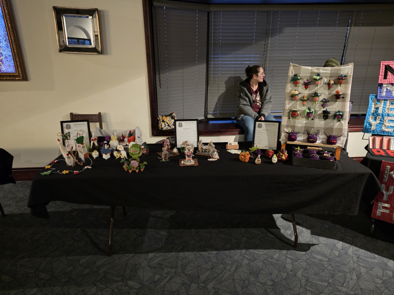 An art display filled with felted creations