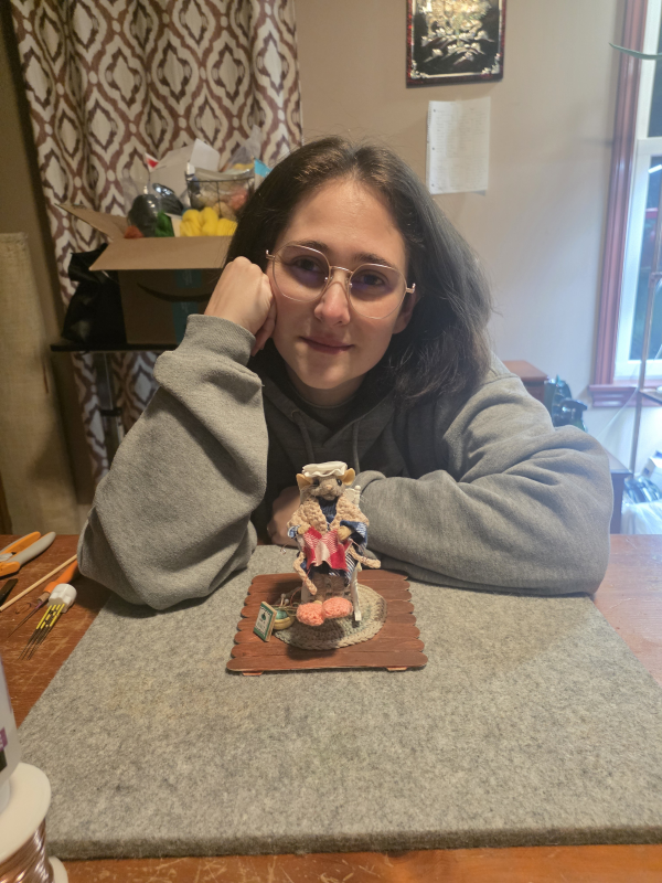 An artist posing with her felted mouse vignette