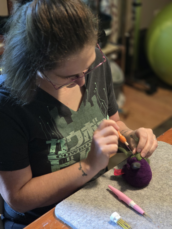 An artist working on a felt Deviled Eggplant